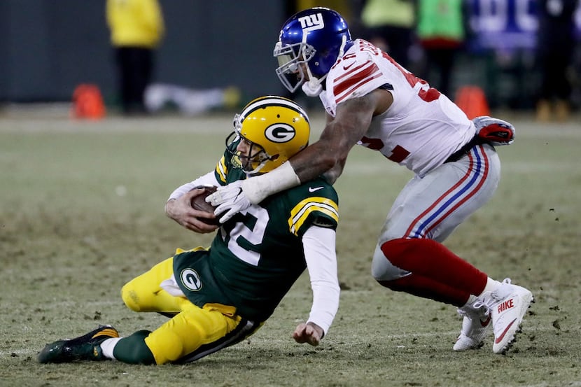 GREEN BAY, WI - JANUARY 8:  Jonathan Casillas #52 of the New York Giants tackles Aaron...