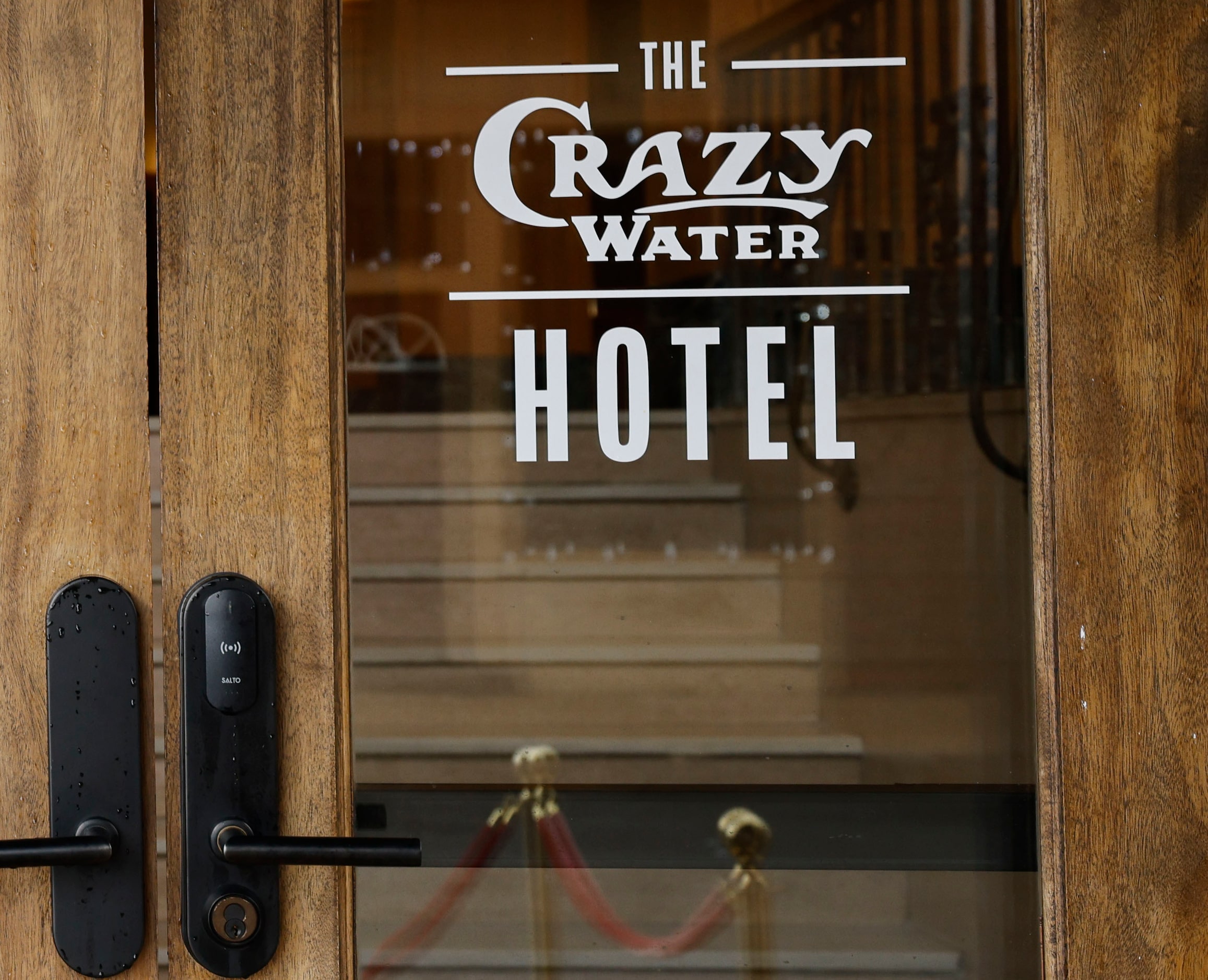 The Crazy Water Hotel ’s logo is seen on a door of the hotel. It's had this name since it...