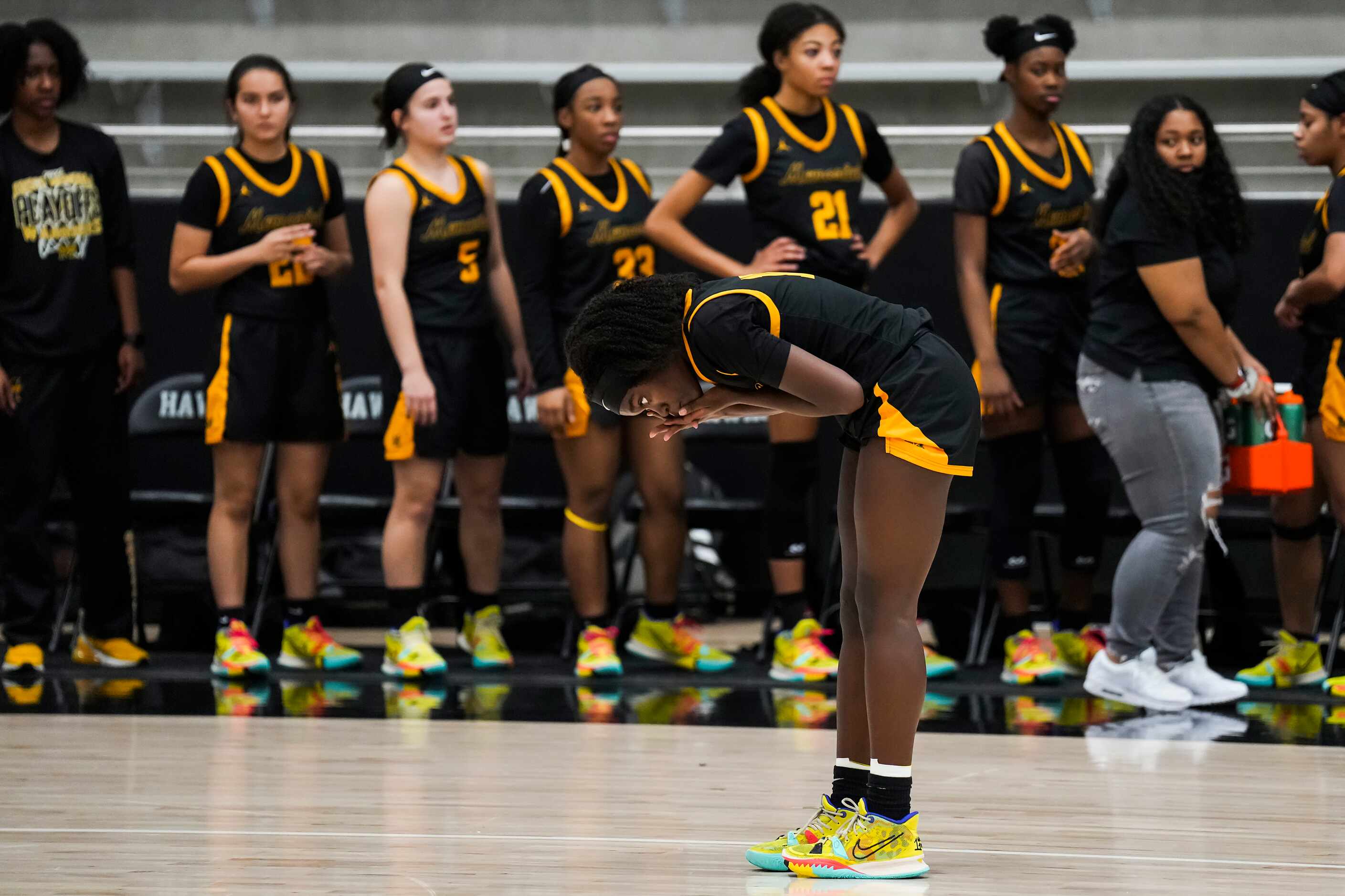 Frisco Memorial's Jasmyn Lott pauses to replace a contact lens after hitting a shot during a...