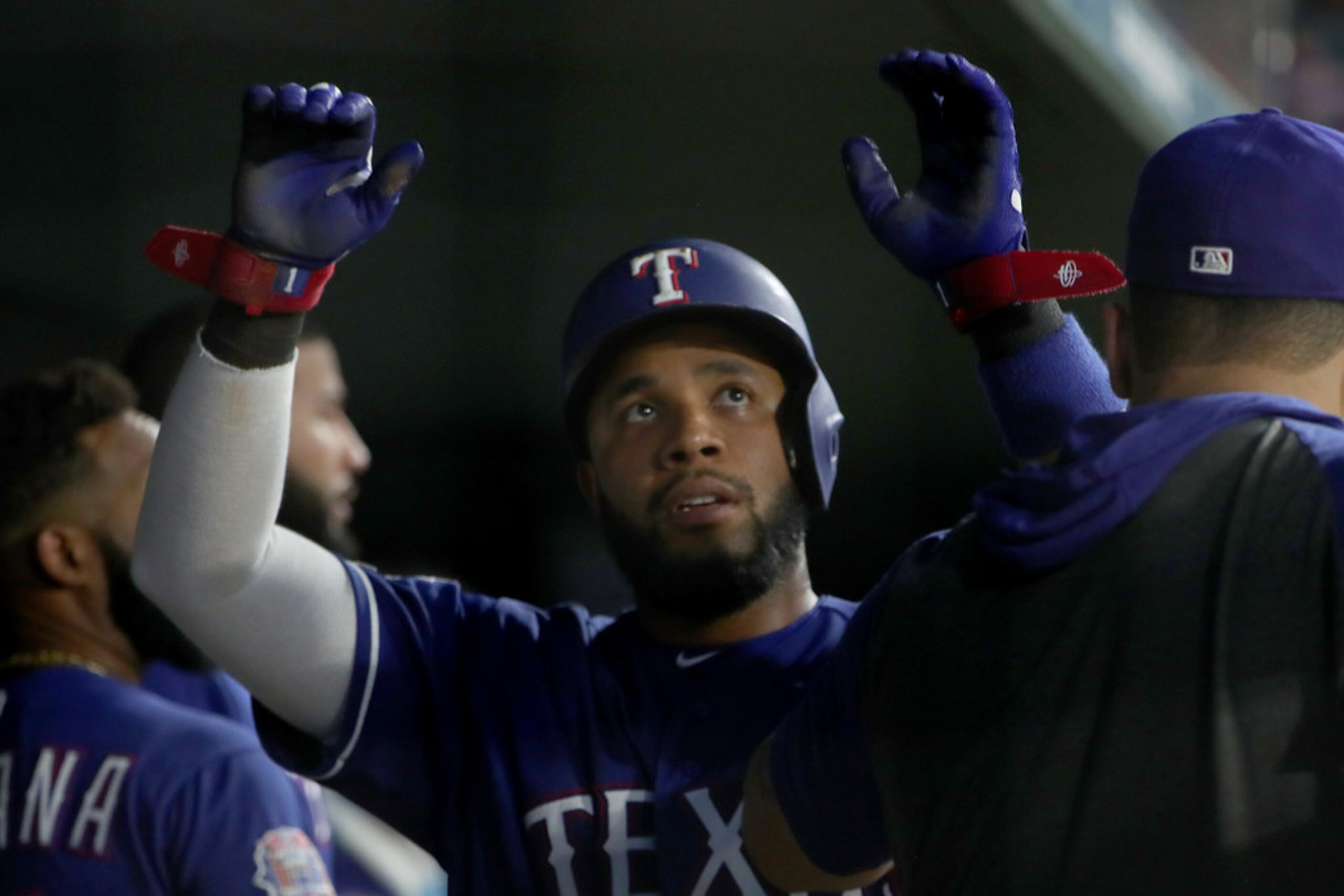 ARLINGTON, TEXAS - AUGUST 16: Elvis Andrus #1 of the Texas Rangers celebrates after scoring...