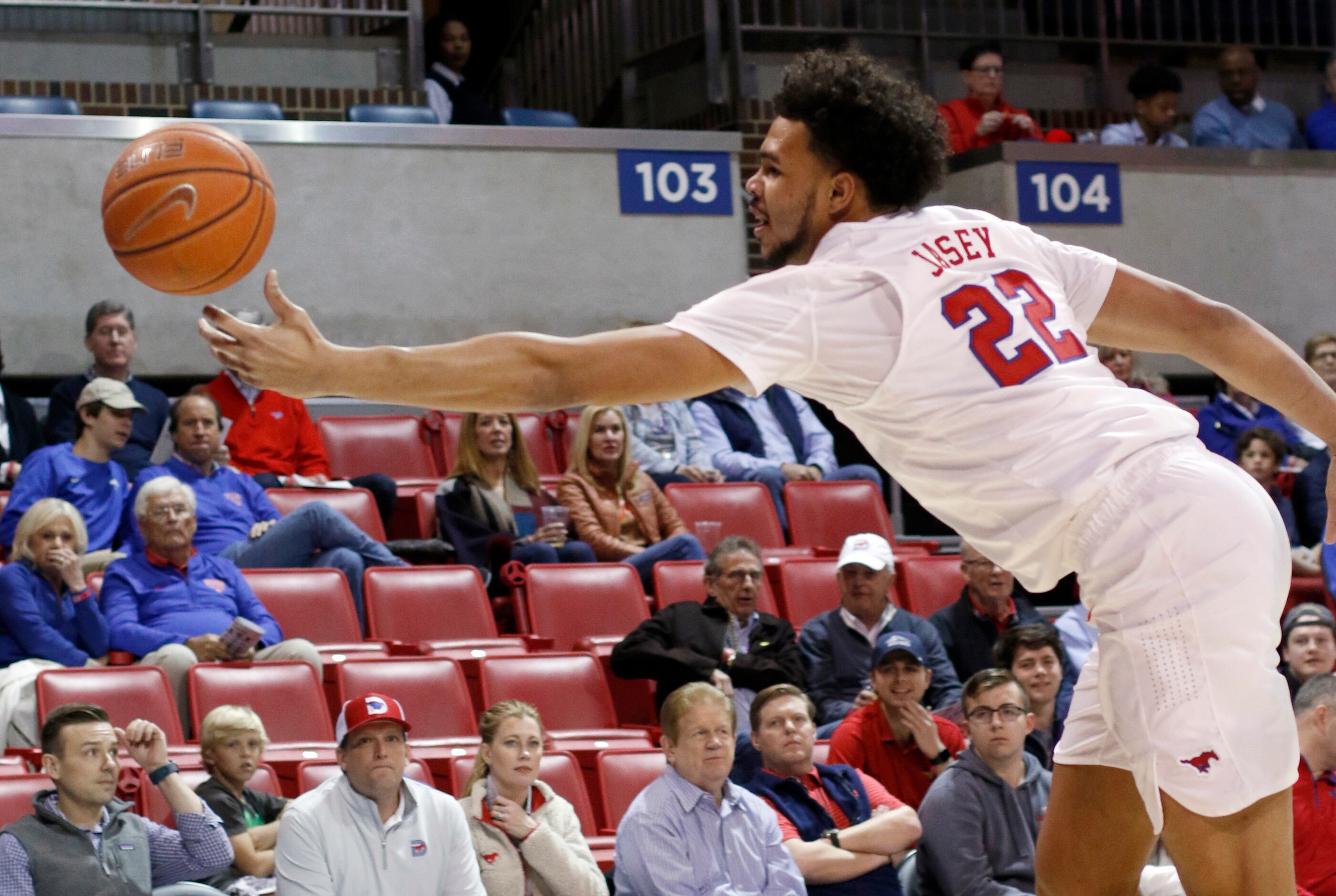 SMU forward Isiah Jasey (22) lunges to keep an errant pass alive during first half action...