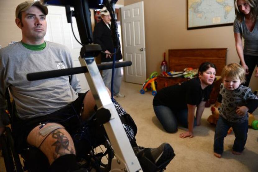 
Colbert does therapy while his wife, Emily, and son, Deagan, play at their home. Colbert...