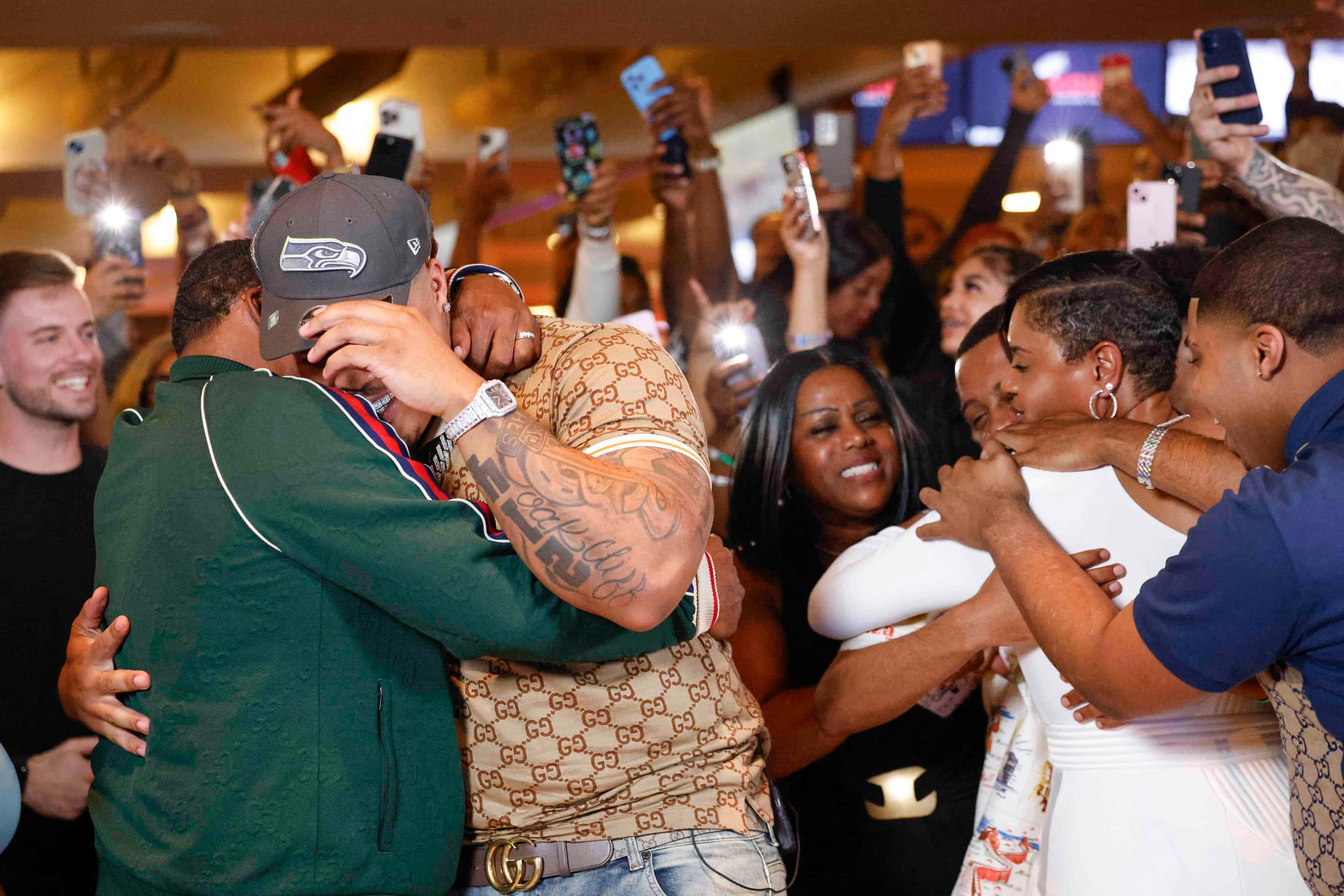  Texas defensive tackle Byron Murphy II, (left back) from DeSoto, embraces his father Byron...