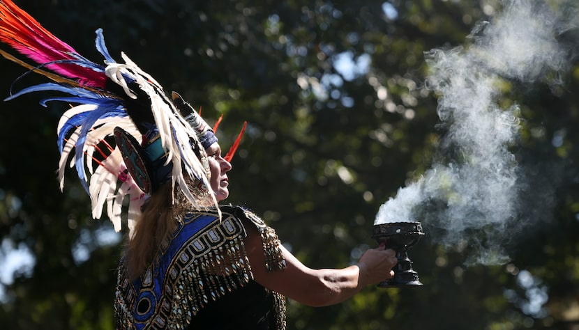 Graciela Solorio performs a traditional ritual during Aztec dancers performance on the main...