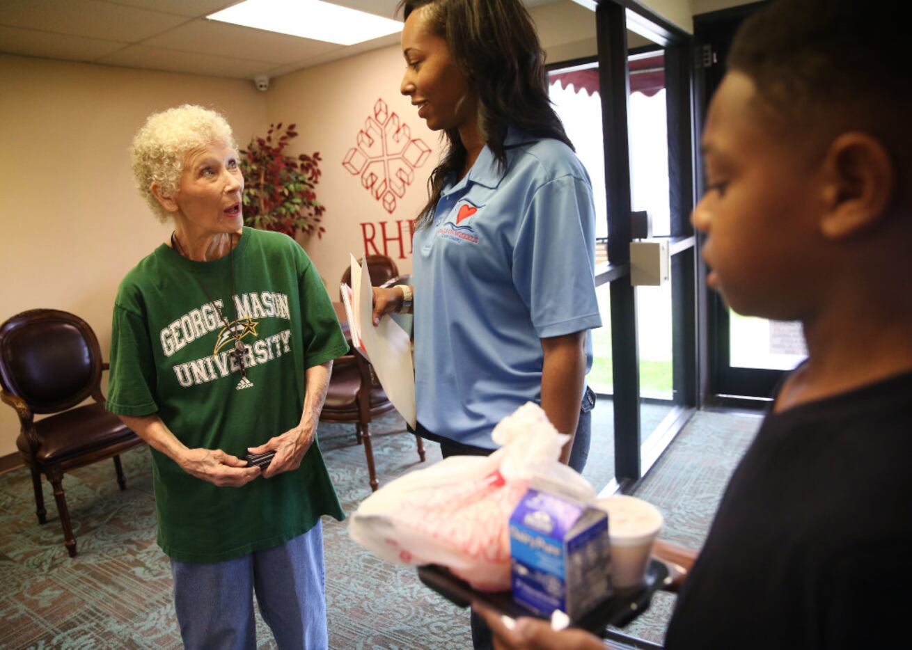 Eboni Crayton (middle) of Meals on Wheels of Collin County and her stepson, Emory Jones,...