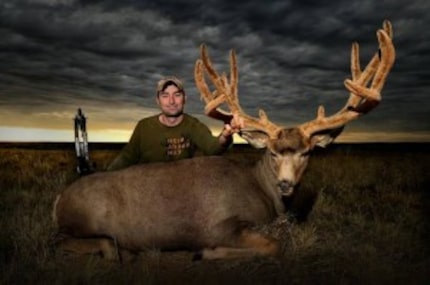  Corey Knowlton with a buck he shot while bow-hunting.