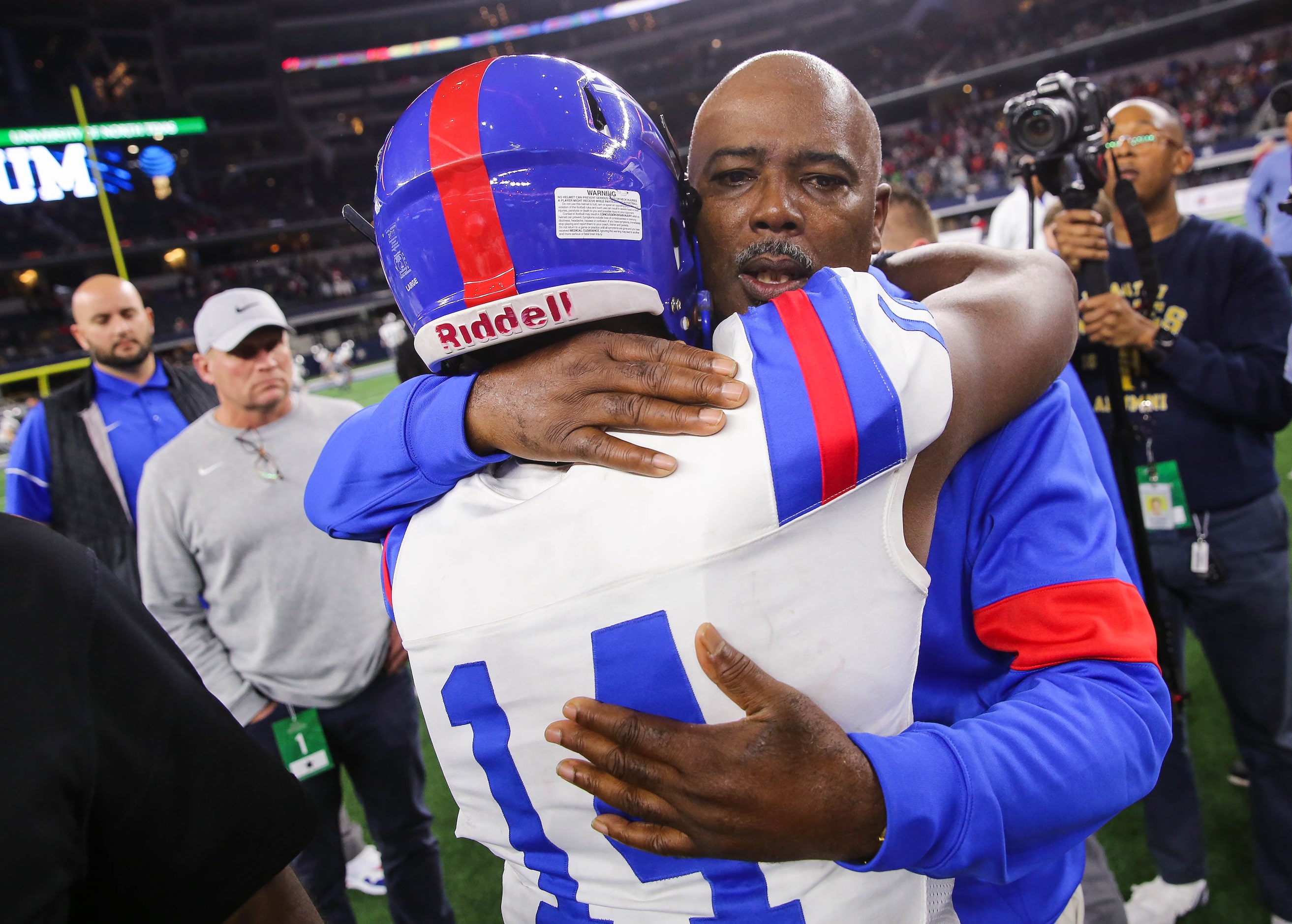 Duncanville's coach Reginald Samples consoles quarterback Chris Parson (14) after losing a...