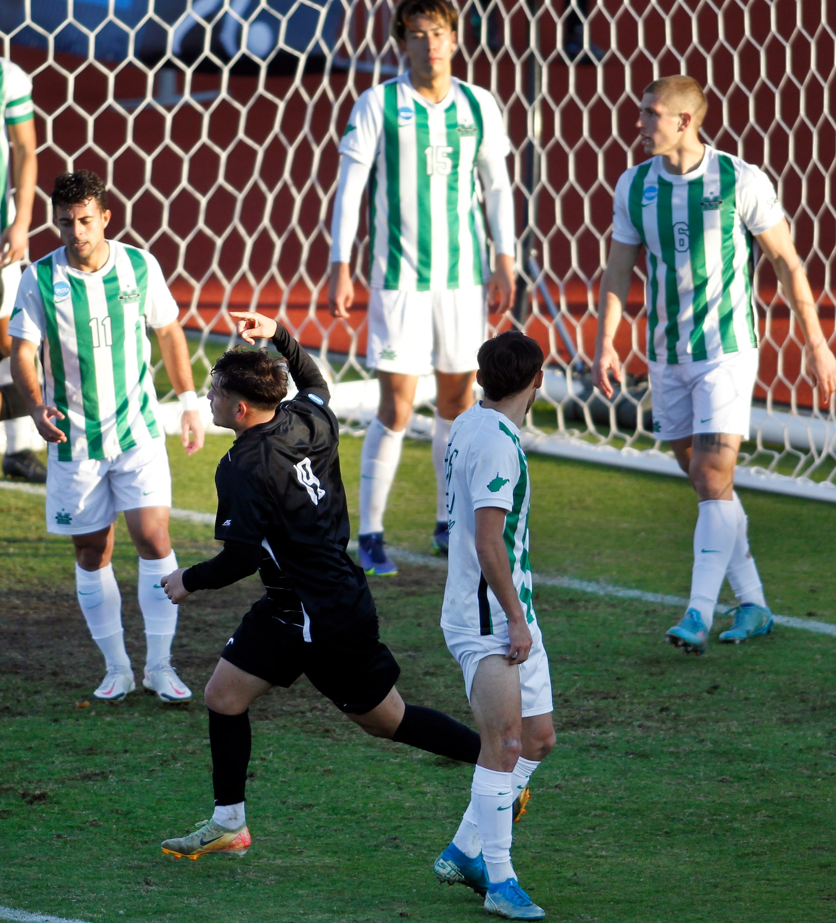 SMU forward Milton Lopez (19), lower left, bolts toward the pitch to celebrate his second...