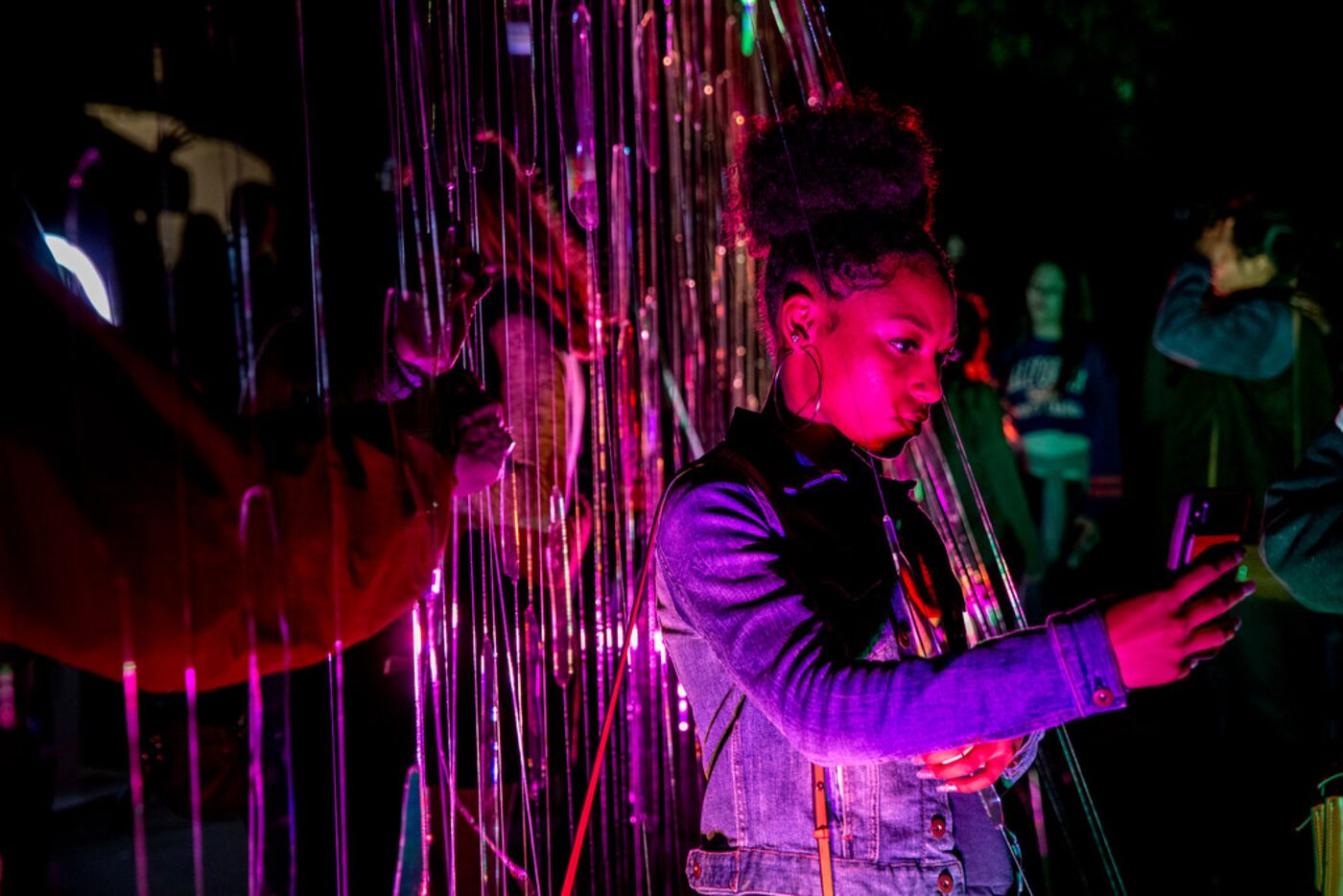 Chandler Garrison, 18, of Atlanta, takes a picture at an exhibit during AURORA in Downtown...