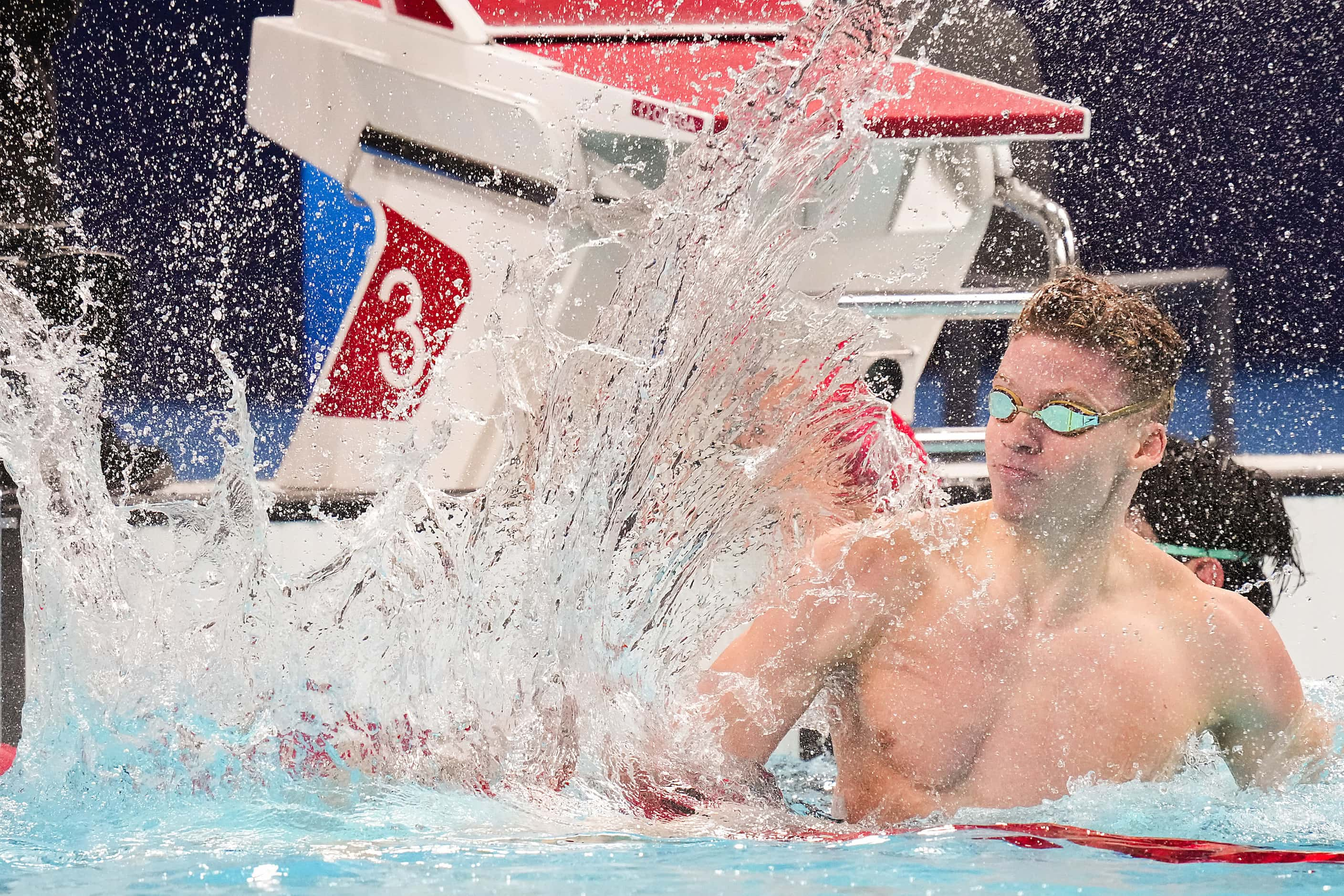 Fans cheer Leon Marchand of France celebrates after winning the men’s 200-meter breaststroke...