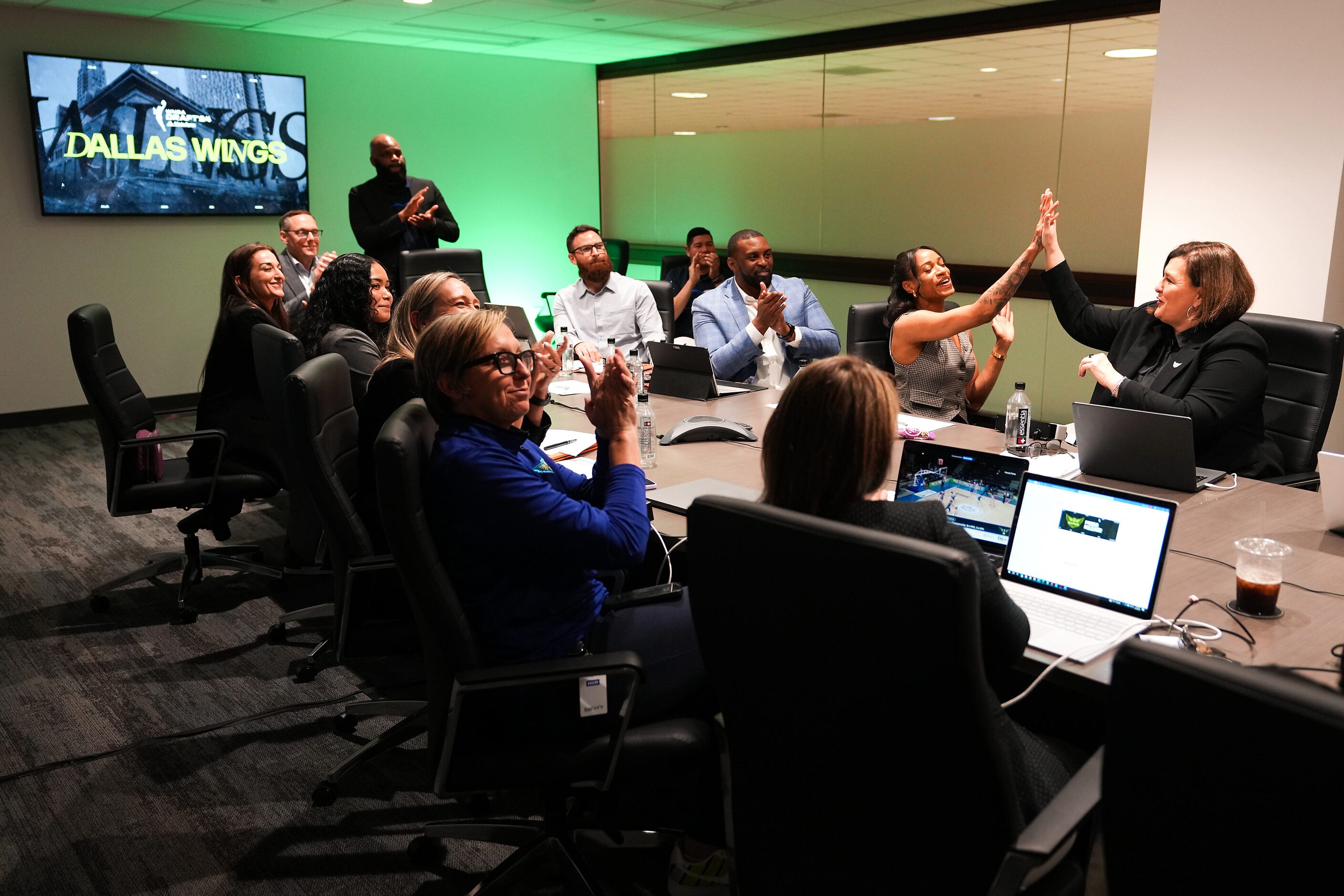 Dallas Wings head coach Latricia Trammell (right) high-fives Jasmine Thomas, director of...