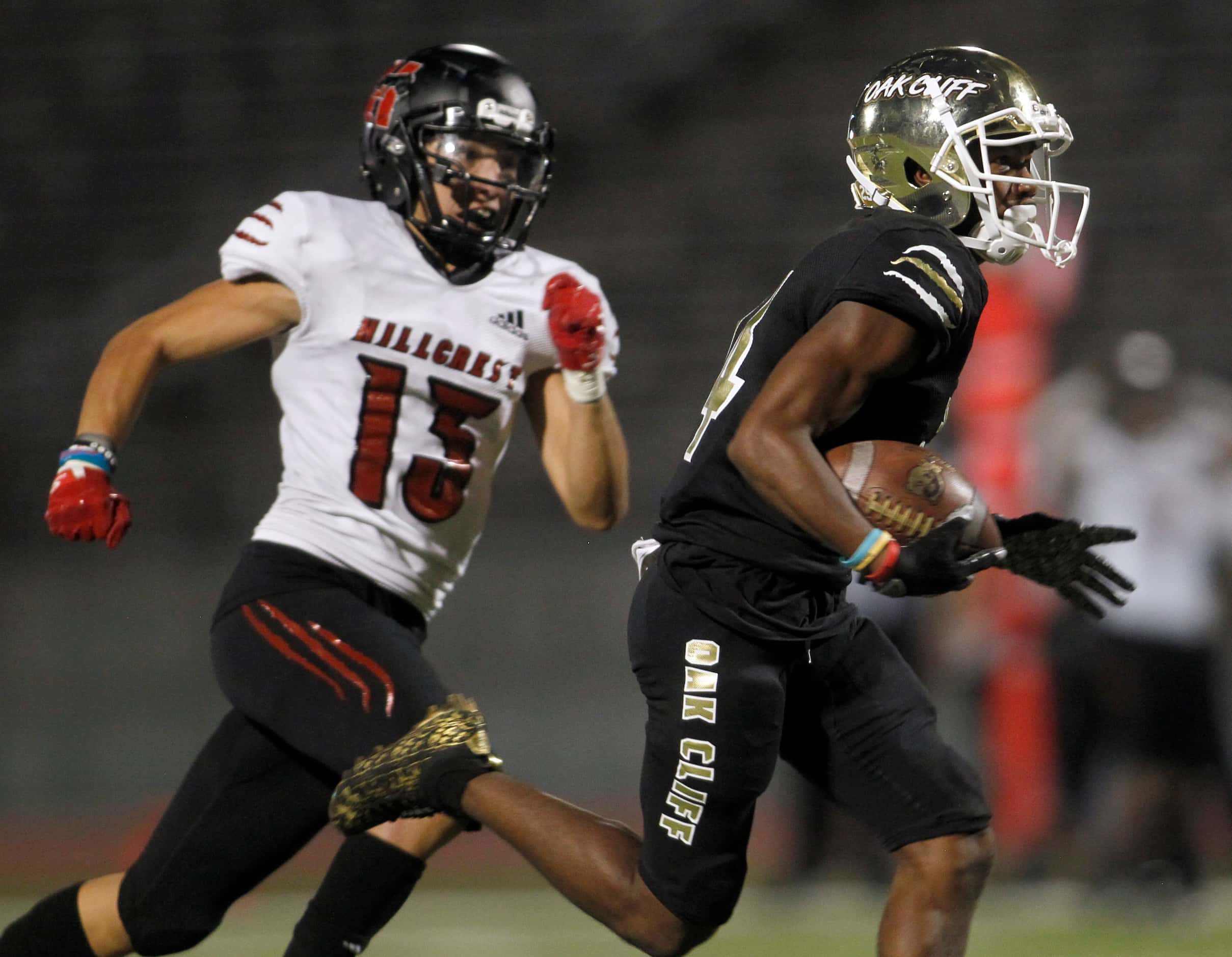 South Oak Cliff receiver Corinthean Coleman (14), right, pulls away from Dallas Hillcrest...