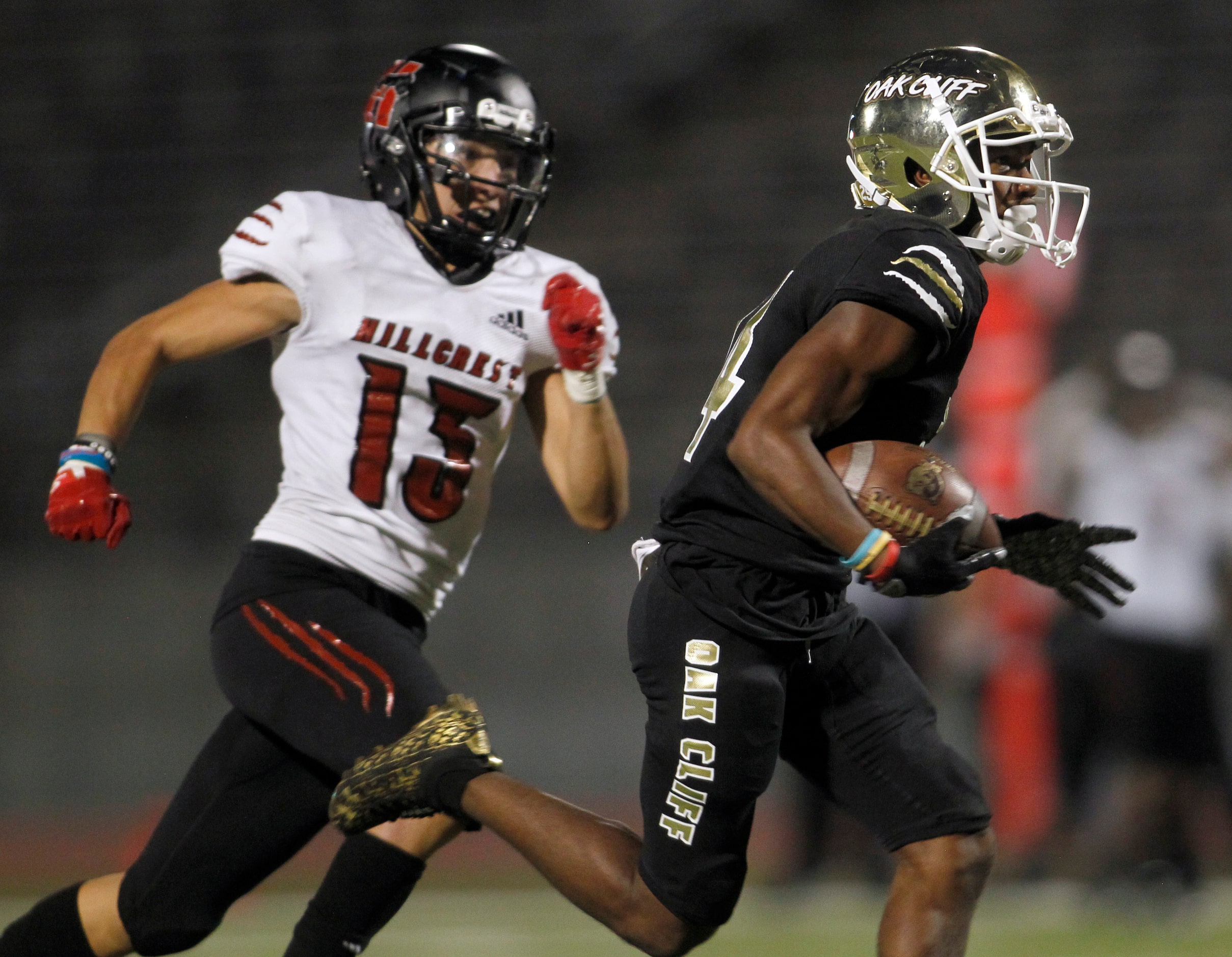 South Oak Cliff receiver Corinthean Coleman (14), right, pulls away from Dallas Hillcrest...