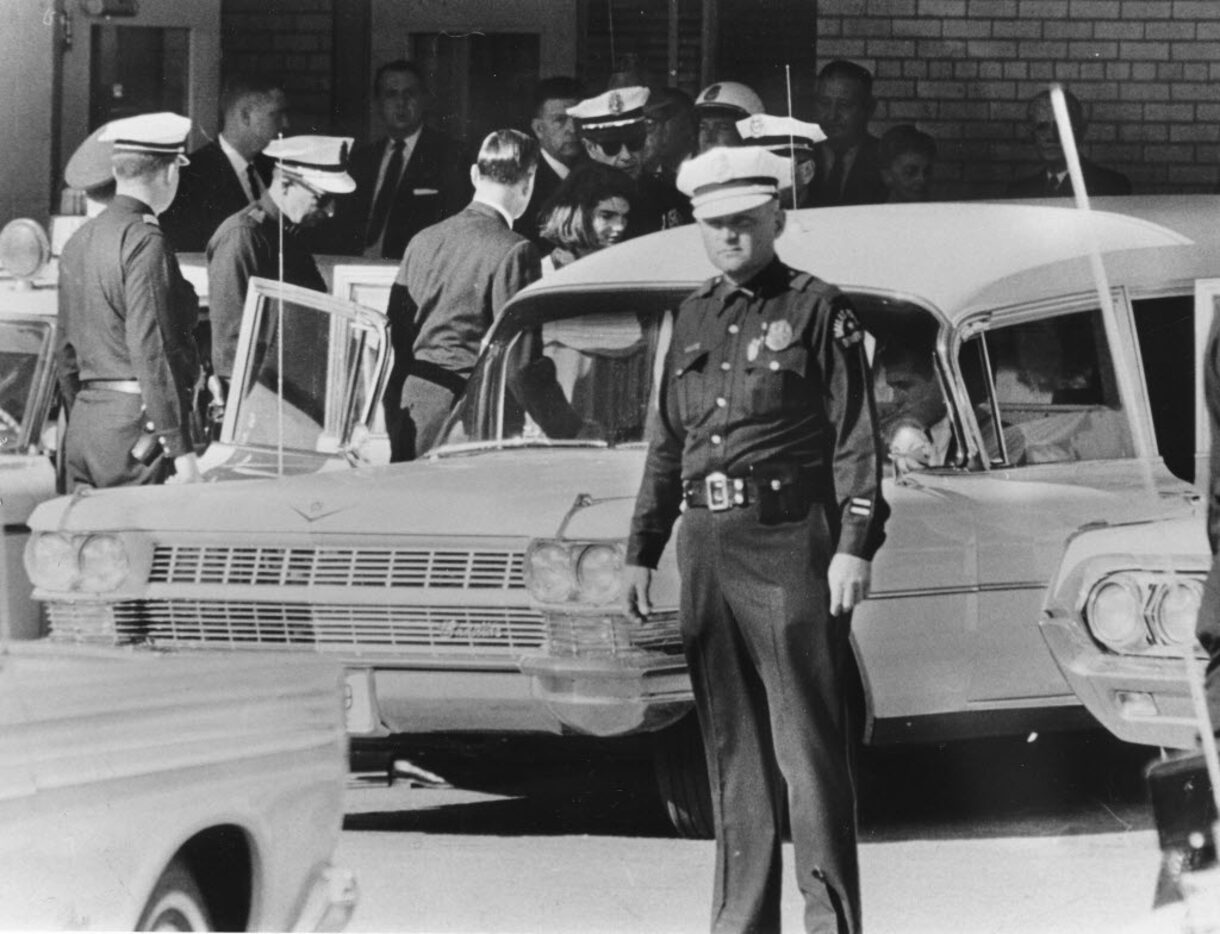 At Parkland Memorial Hospital, first lady Jacqueline Kennedy is ushered into the hearse...