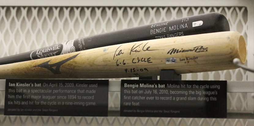 Bats from former Texas Rangers Bengie Molina and Ian Kinsler are on display in the Texas...