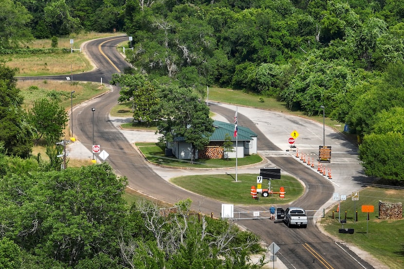 A vehicle pauses at the locked gates of Fairfield Lake State Park on Monday, June 5, 2023,...