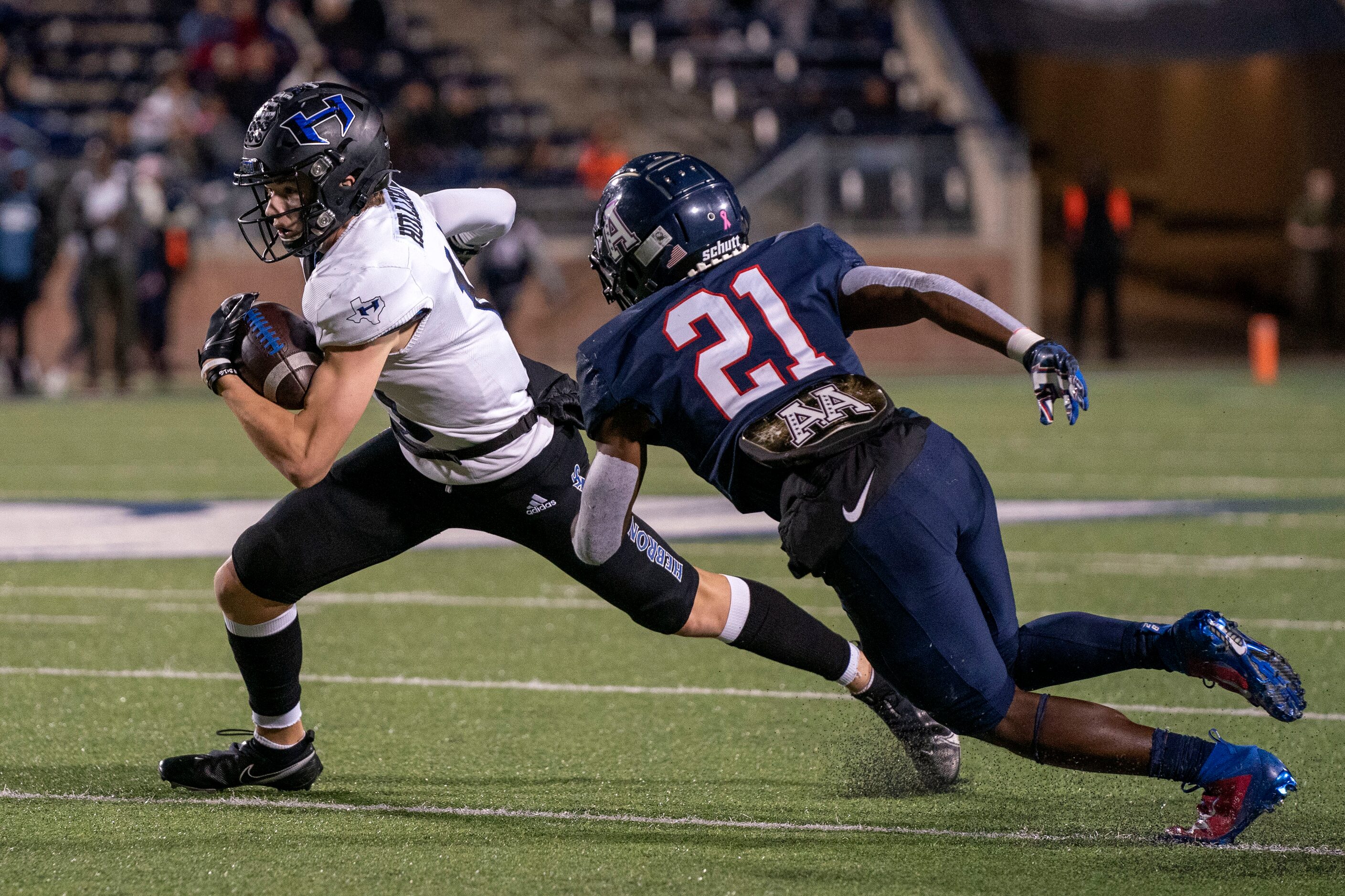 Hebron wide receiver Case Holleron (11) tries to get past Allen senior defensive back...