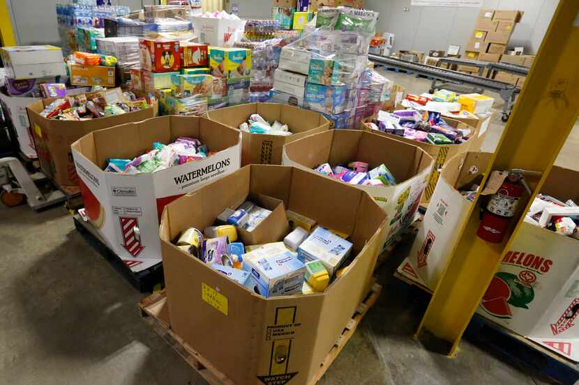 Chefs' Produce staff prepares donations at the company's Dallas warehouse Friday September...