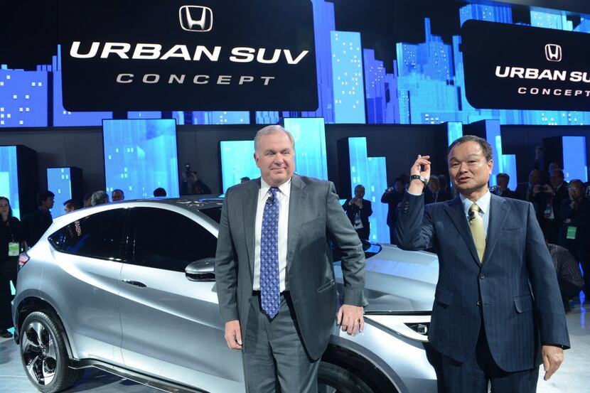 Honda Motor Company President and CEO Takanobu Ito (R) and John Mendel, American Honda...