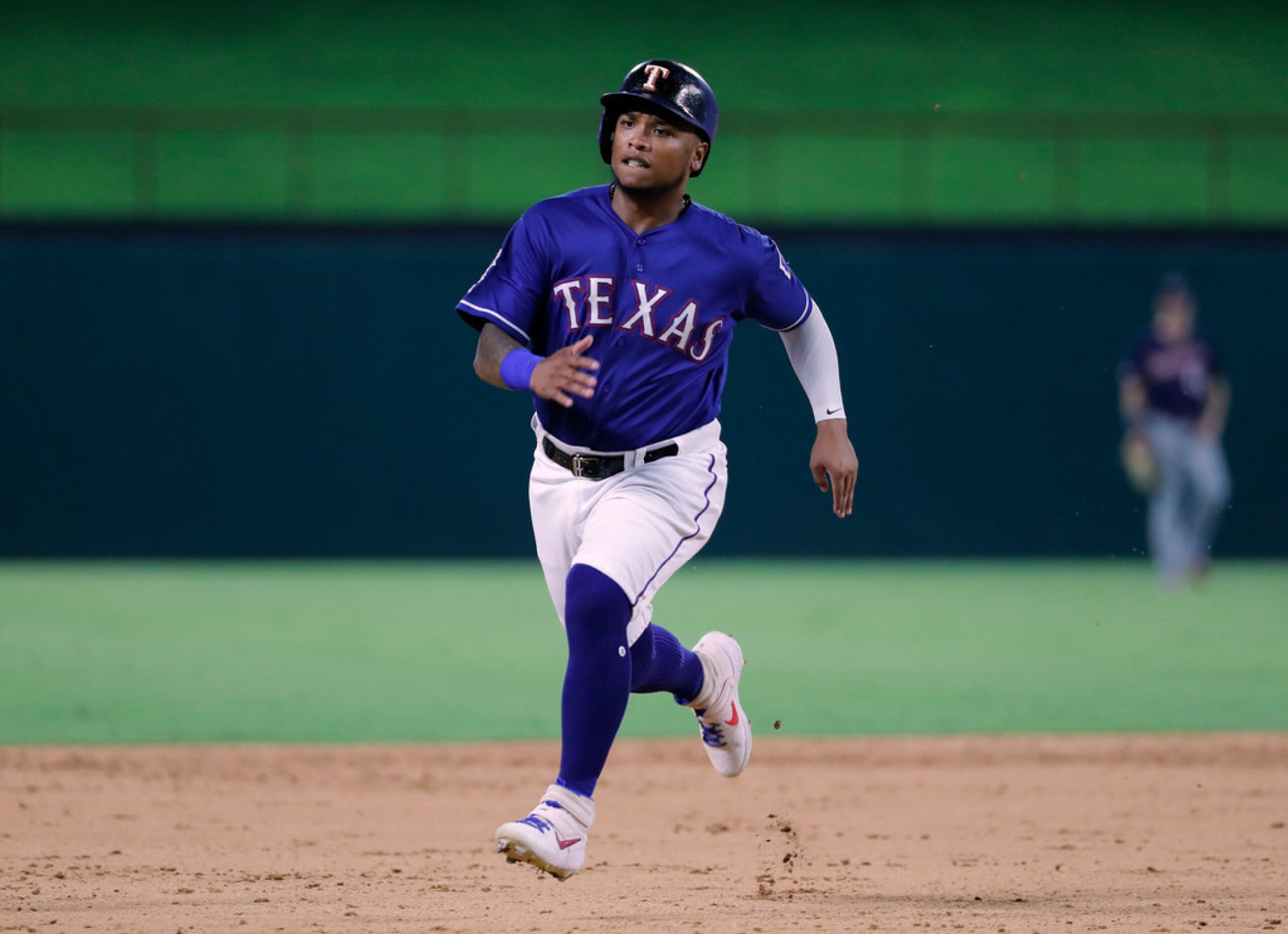 Texas Rangers' Willie Calhoun advances to third on a single by Nomar Mazara during the...