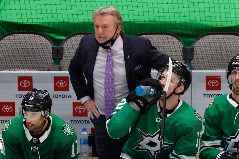 Dallas Stars head coach Rick Bowness (center) is angry with the a referee's interference...