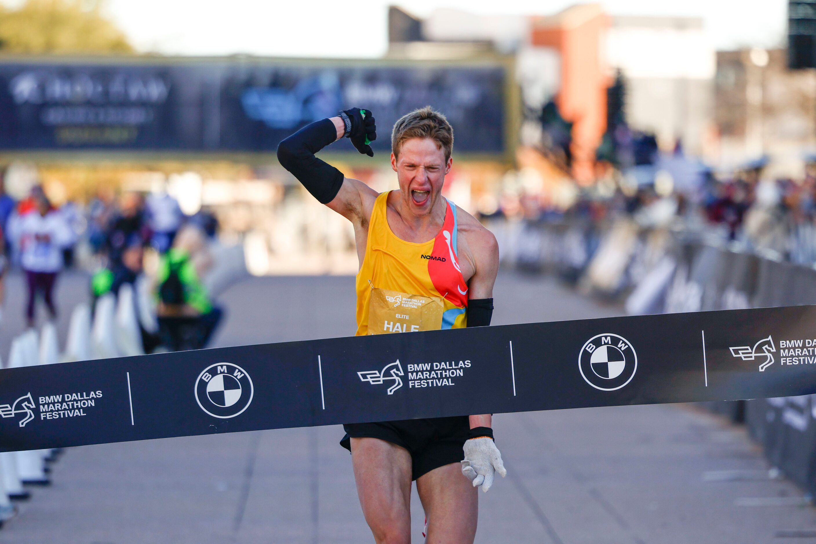 Men’s marathon finisher Joseph Hale, 30, of Grapevine, celebrates after reaching the finish...