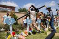 Black crosses were erected at a memorial outside Allen Premium Outlets in Allen on May 8,...