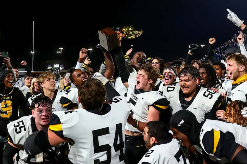The Forney Jackrabbits hold up their trophy as they beat Richland, 61-40 in the Class 5A...