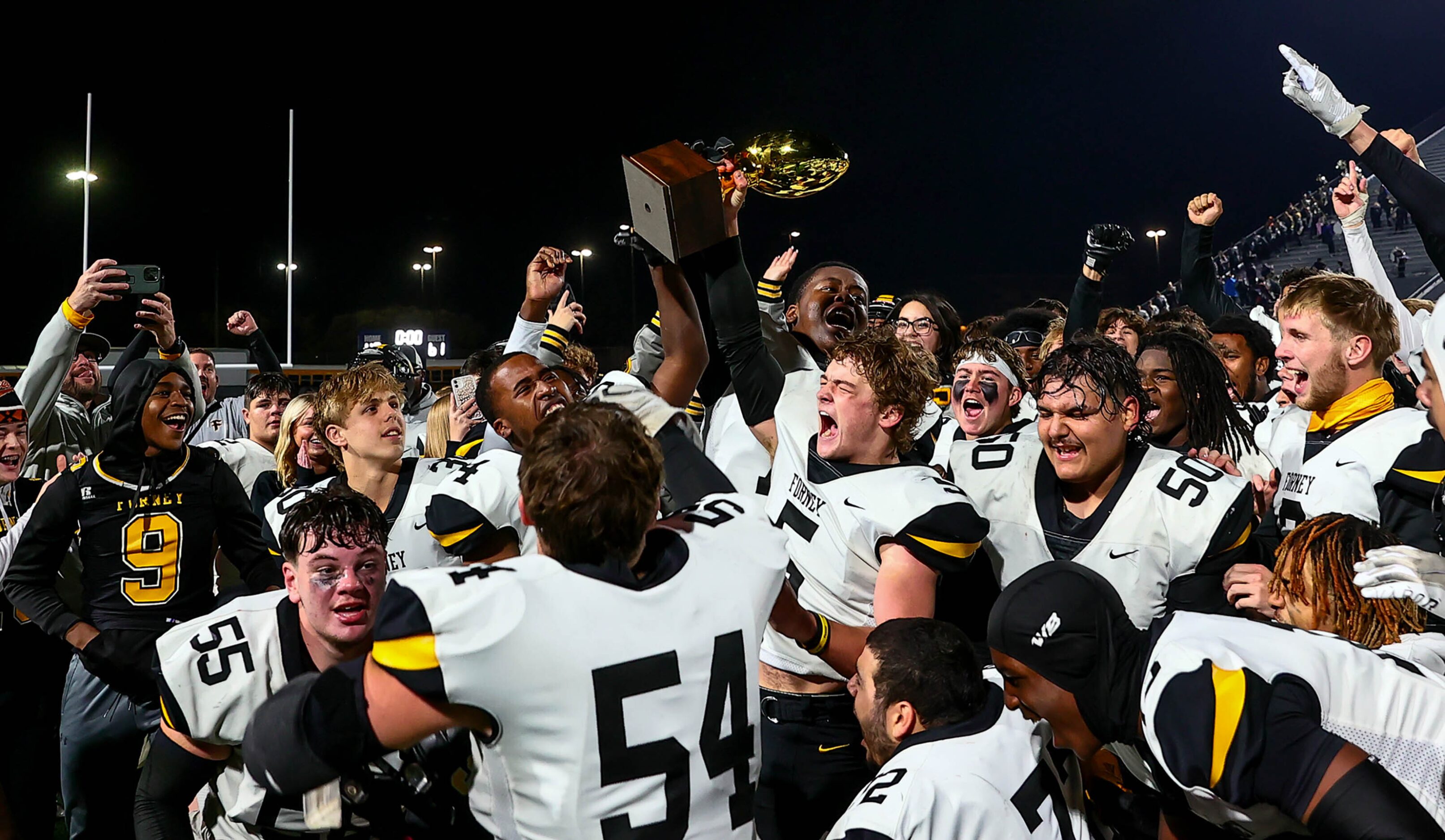 The Forney Jackrabbits hold up their trophy as they beat Richland, 61-40 in the Class 5A...