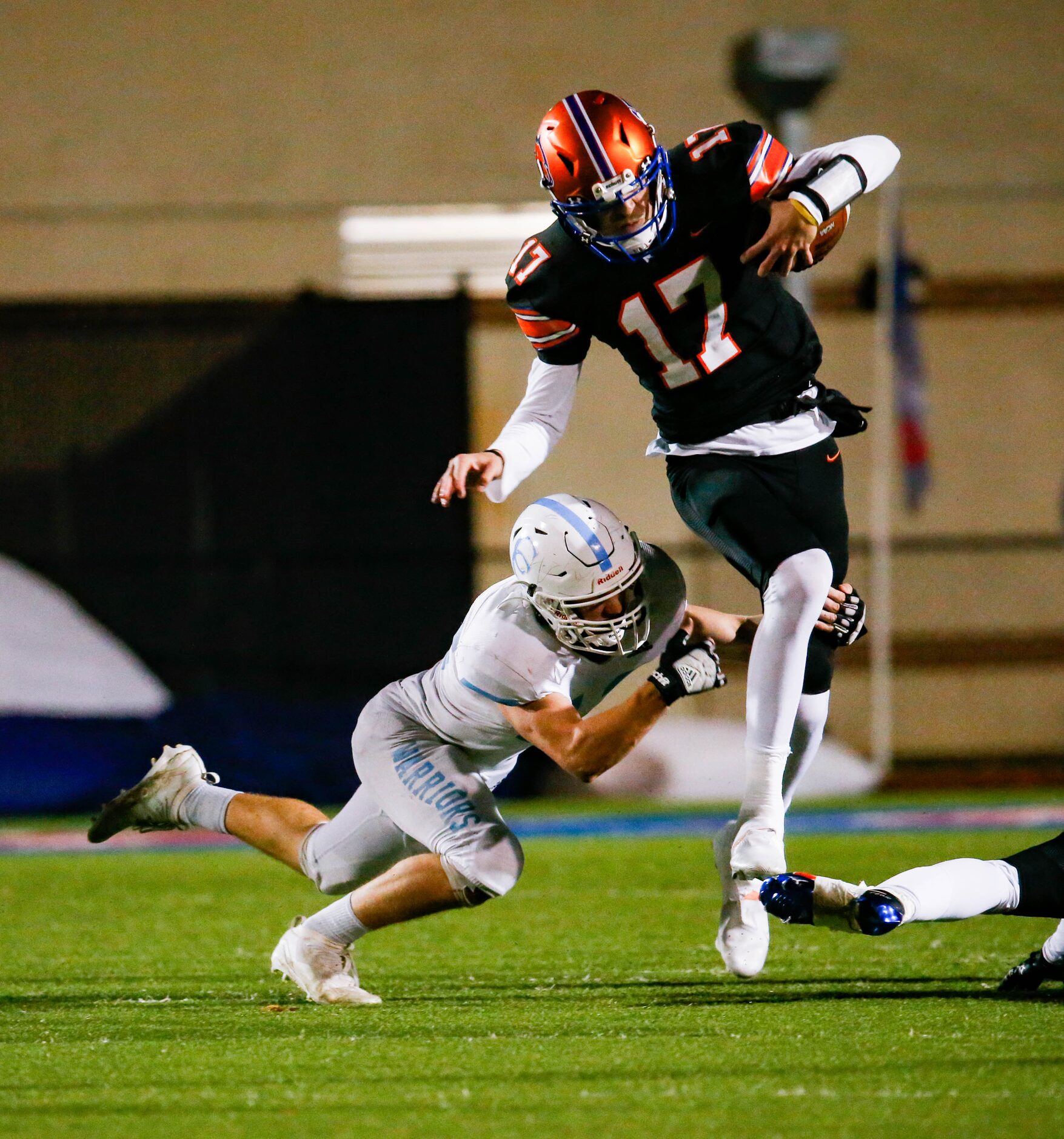 Colleyville Covenant's quarterback Austin Scheets (17) dodges Cypress Christian's John...