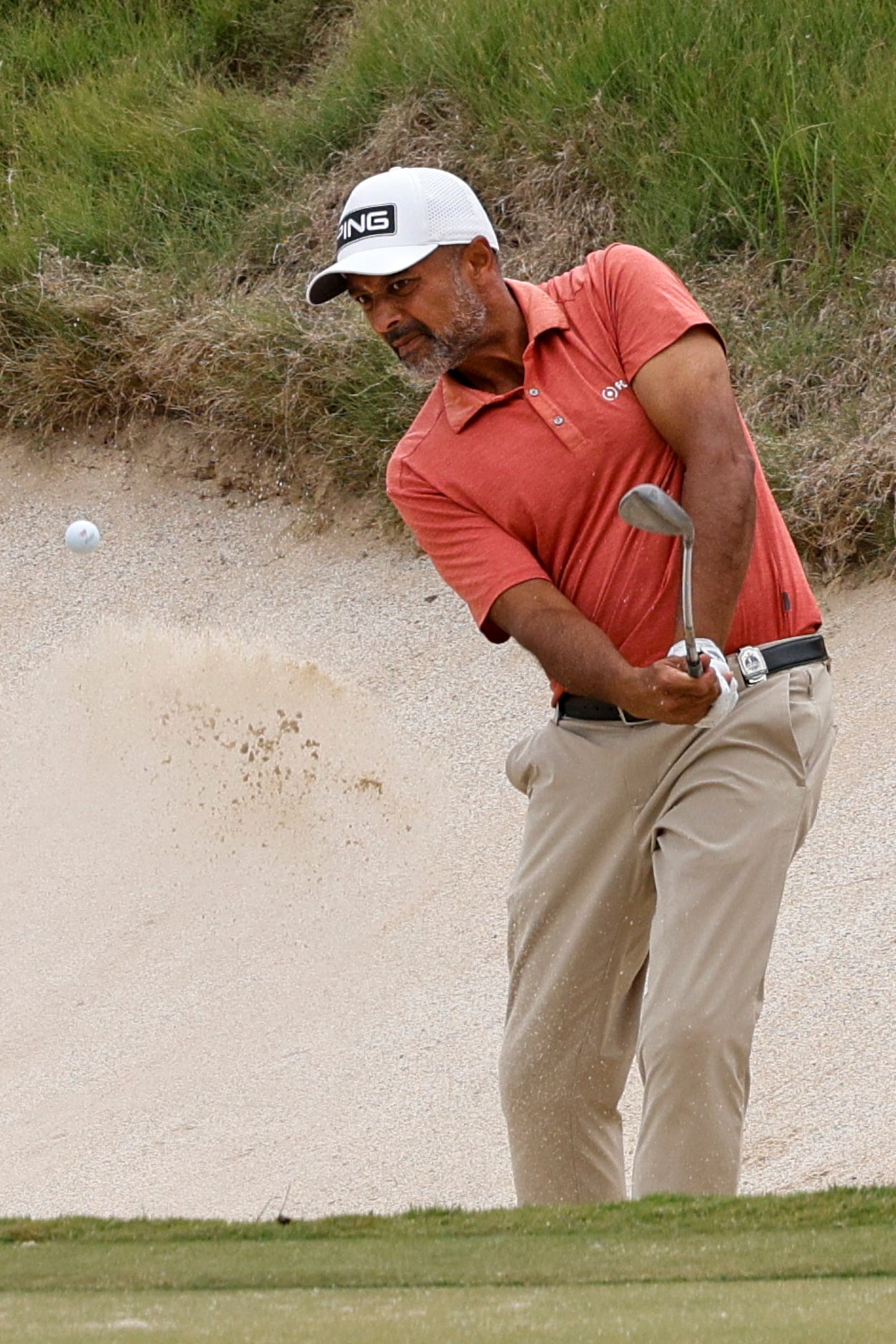 Arjun Atwal of India hits out of a bunker on the 18th hole during the first round of the...