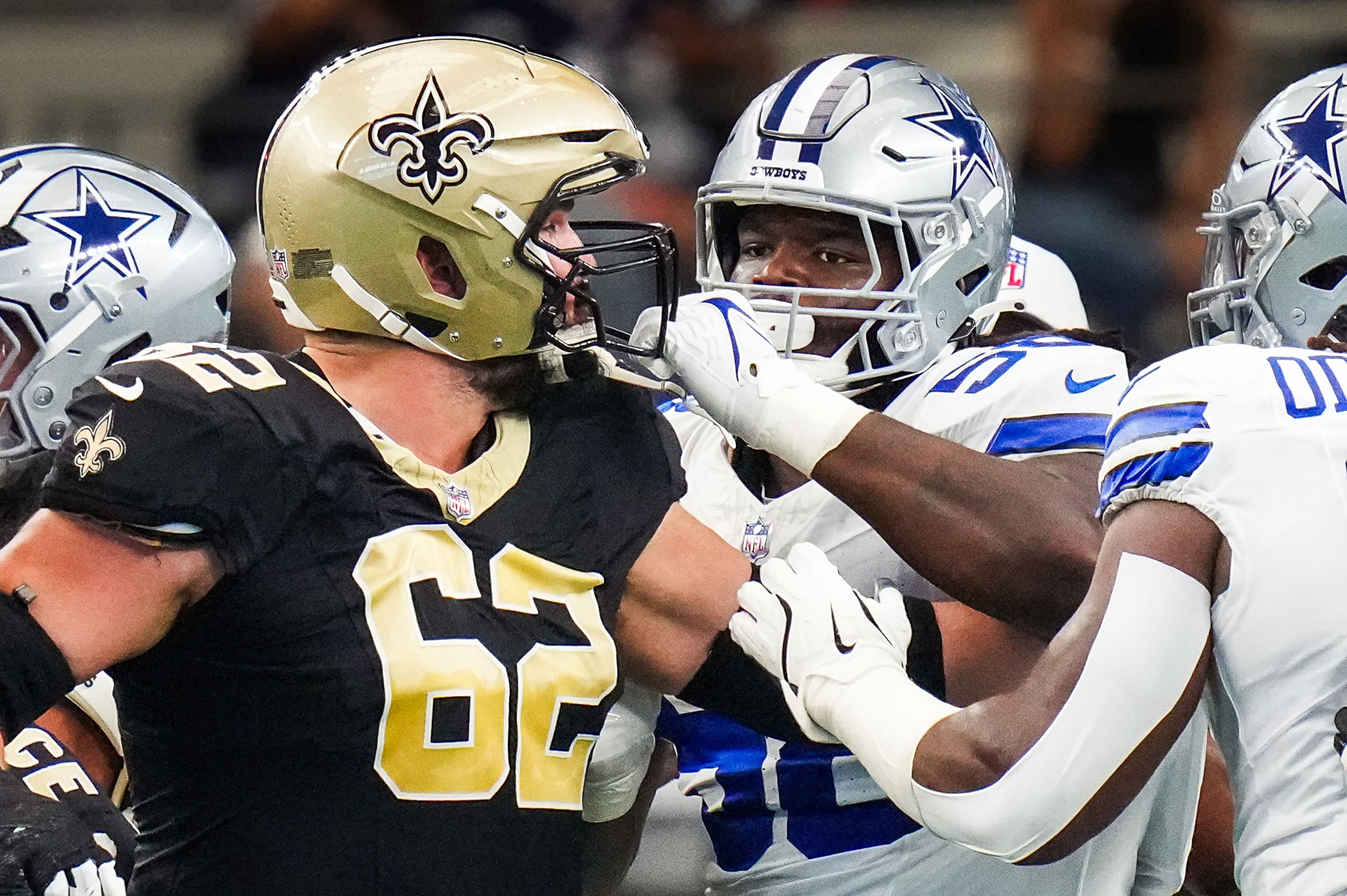 Dallas Cowboys defensive tackle Mazi Smith (58) grabs the facemask of New Orleans Saints...