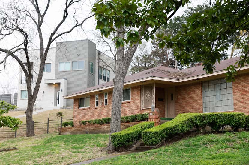 A modern house, left, on Green Castle Drive in Glen Oaks neighborhood in Dallas on Thursday,...