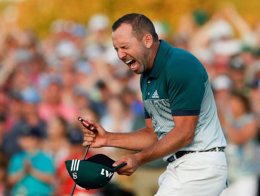 Sergio Garcia, of Spain, reacts after making his birdie putt on the 18th green to win the...