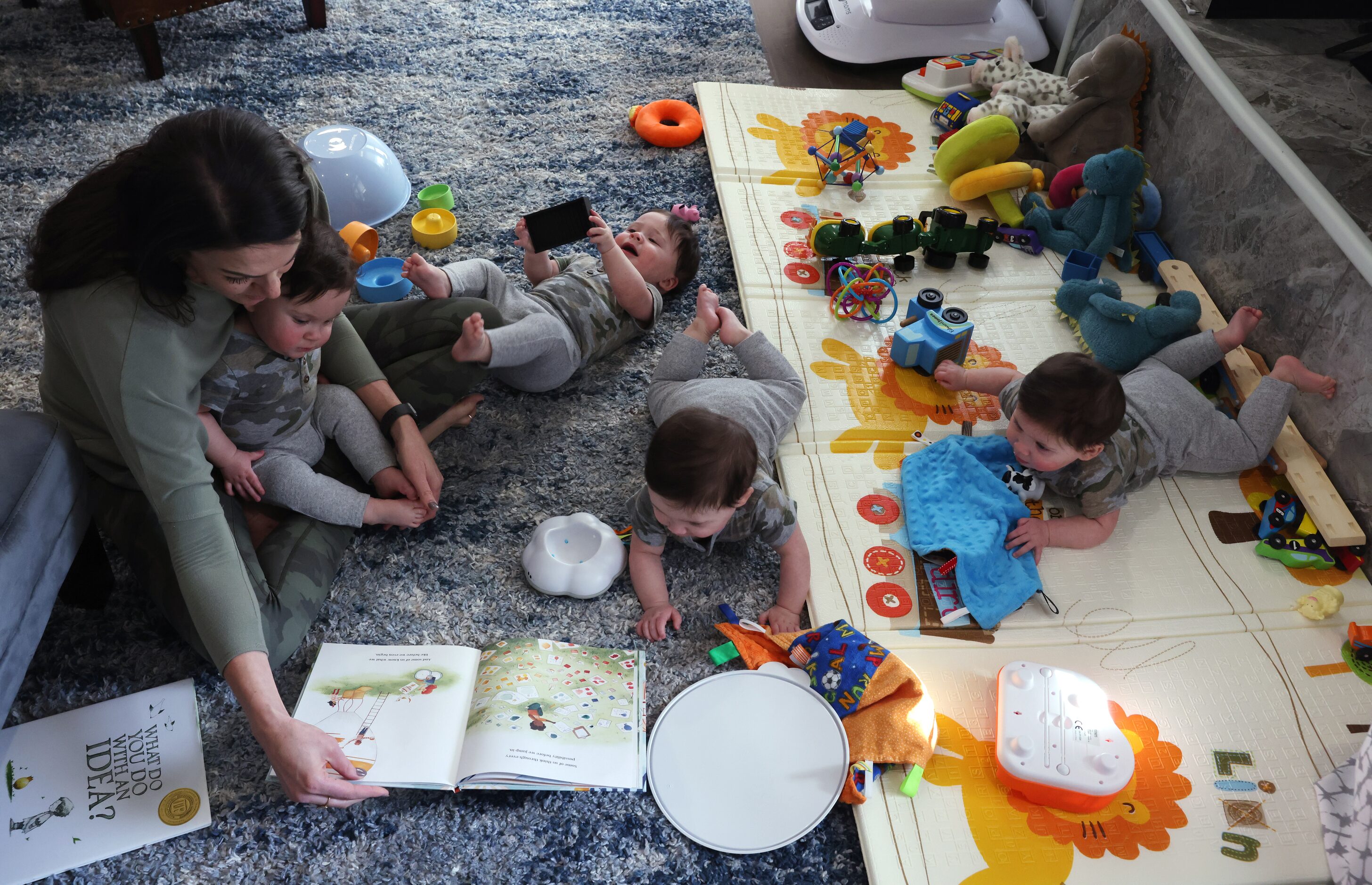 Jenny Marr reads a children's book to  Henry Marr, Harrison Marr, Hudson Marr, and Hardy...