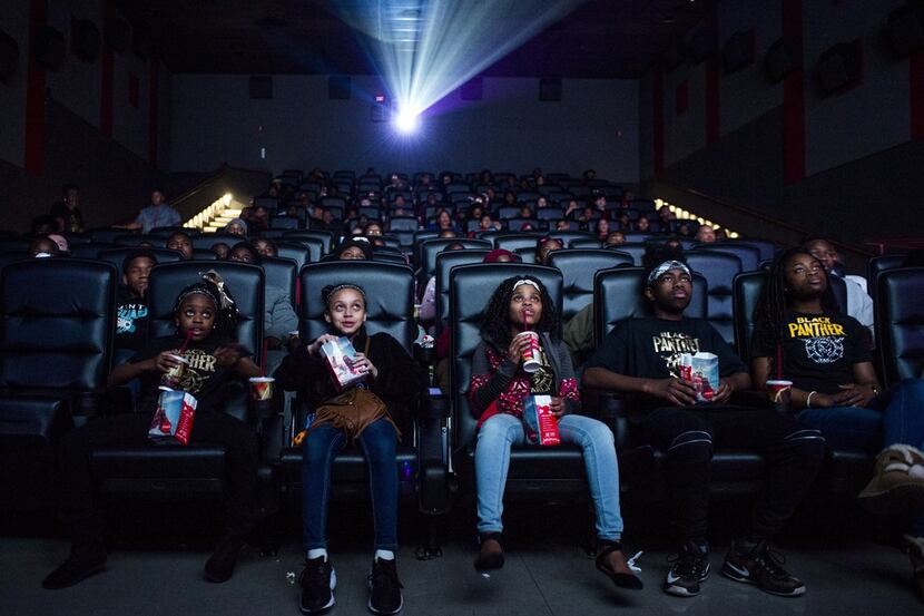 Mari Copeny (third from left) watches a free screening of the film Black Panther with more...