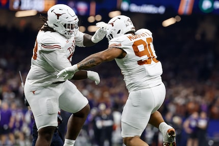 Texas defensive lineman Byron Murphy II (90) celebrates his touchdown against Washington...