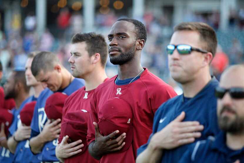 Frisco RoughRiders pitcher Taylor Hearn stands at attention during the national anthem as...