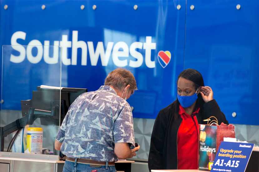Southwest Airlines employee Ericka Thompson assists a customer at Dallas Love Field in...