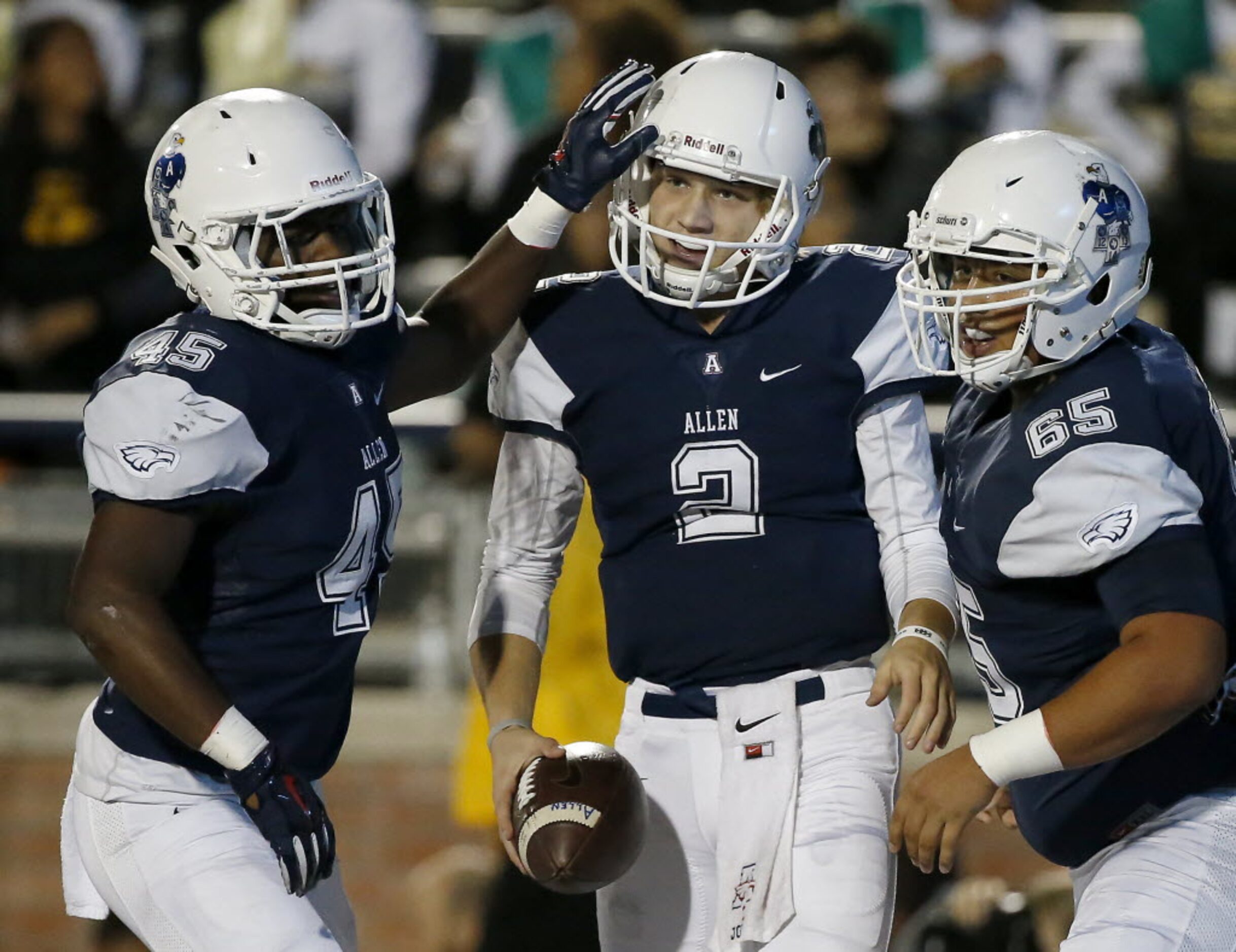 Allen quarterback Mitchell Jonke (2) is congratulated by Kirby Bennett (45) and Conner...