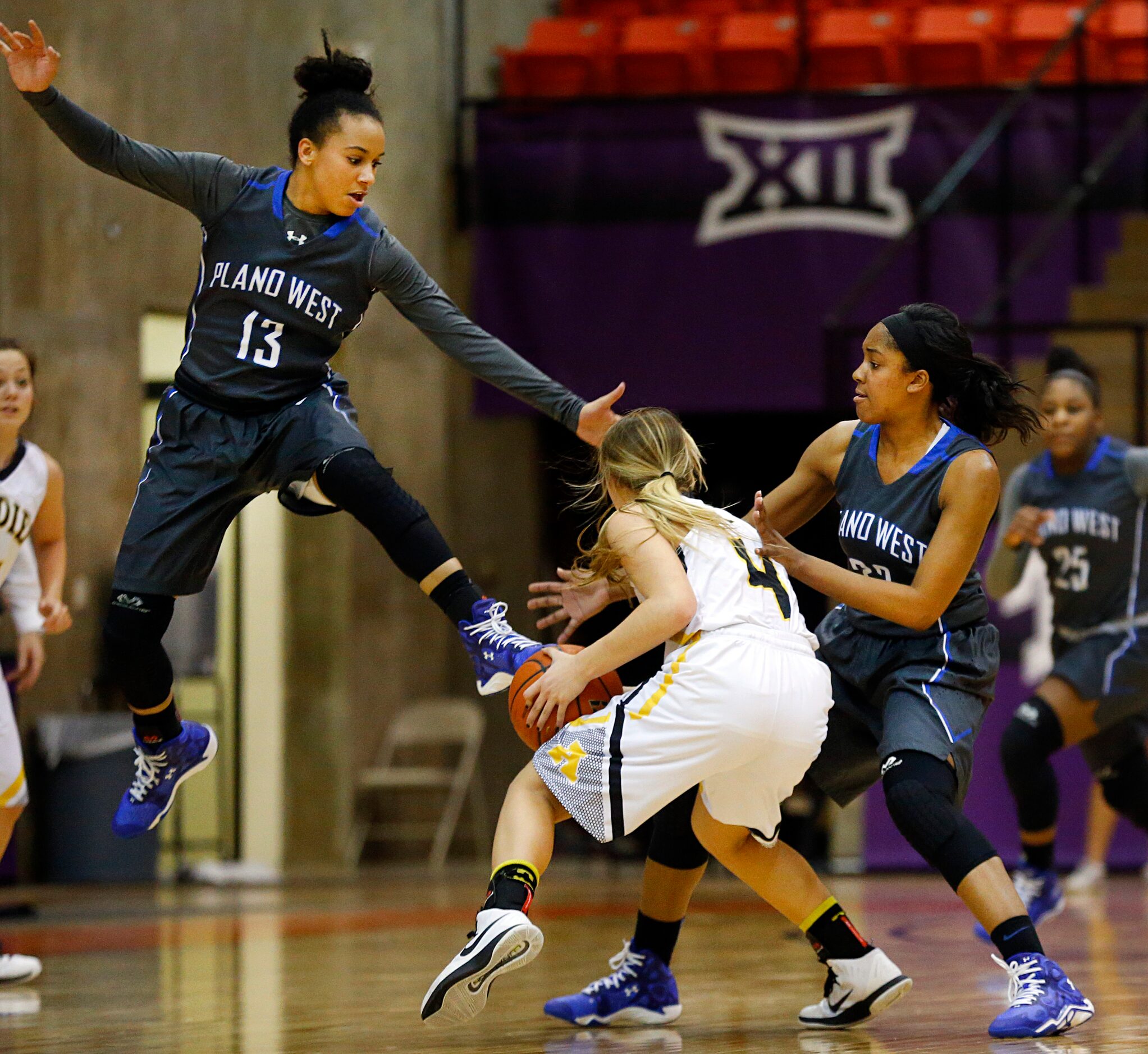 Plano West Callie Owens (13) and post Kyrie McNeil (33) look to make a steal on Amarillo...