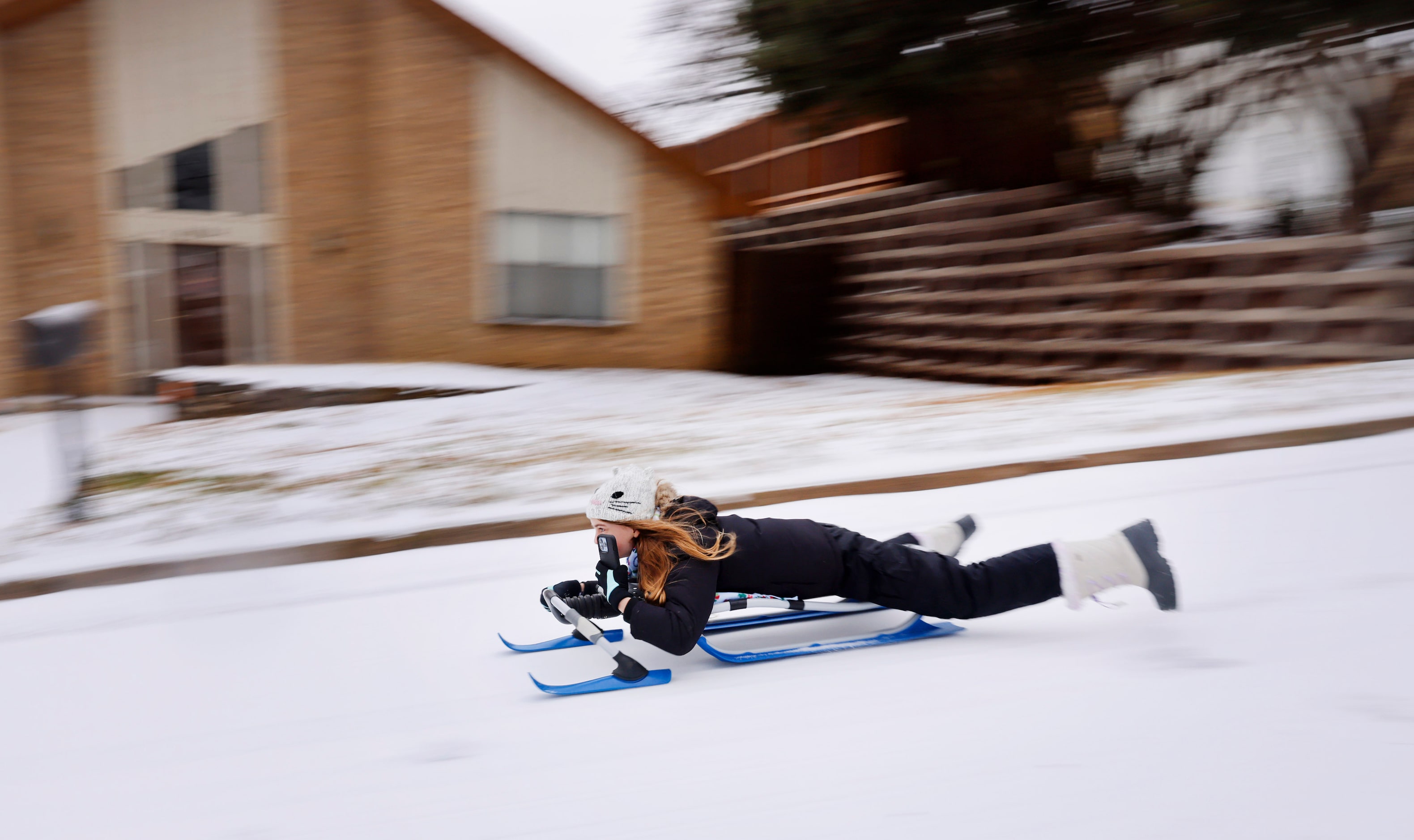 Julia Schack records her run down an icy street in N. Arlington, Texas, after a band of...