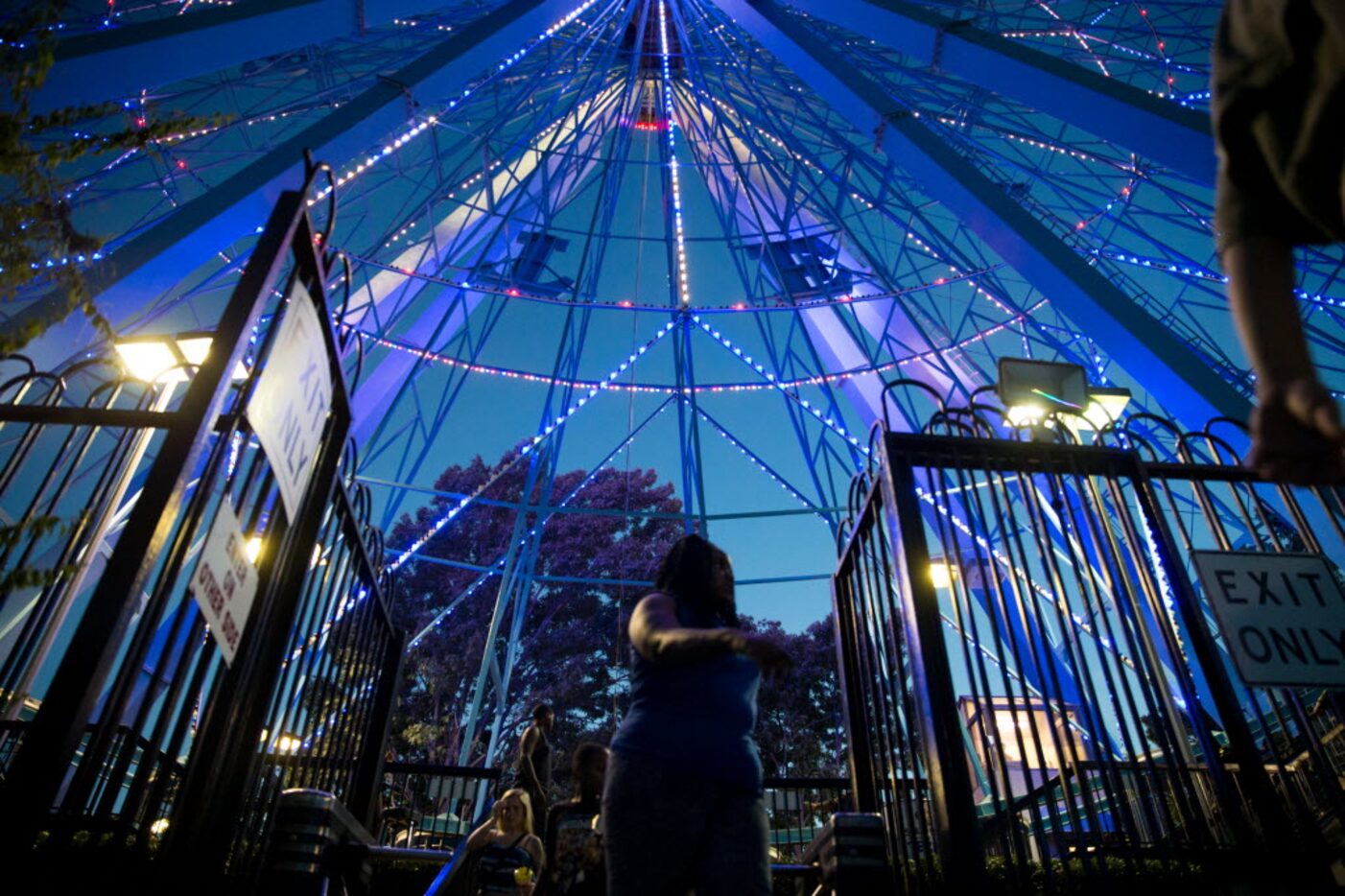 Festival goers exits from the gate after riding on the Texas Star Ferris wheel during the...