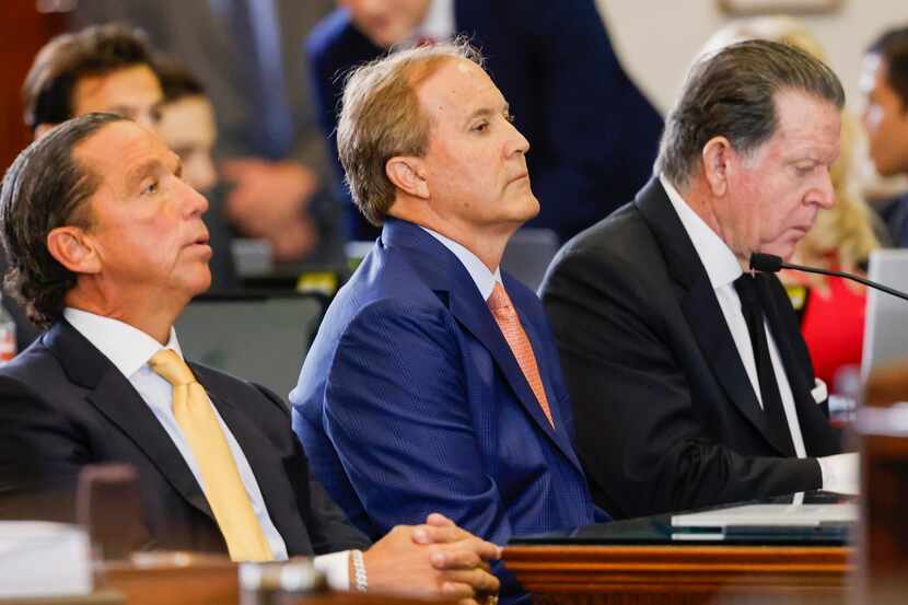 Texas Attorney General Ken Paxton (center) faces removal from office during his impeachment...