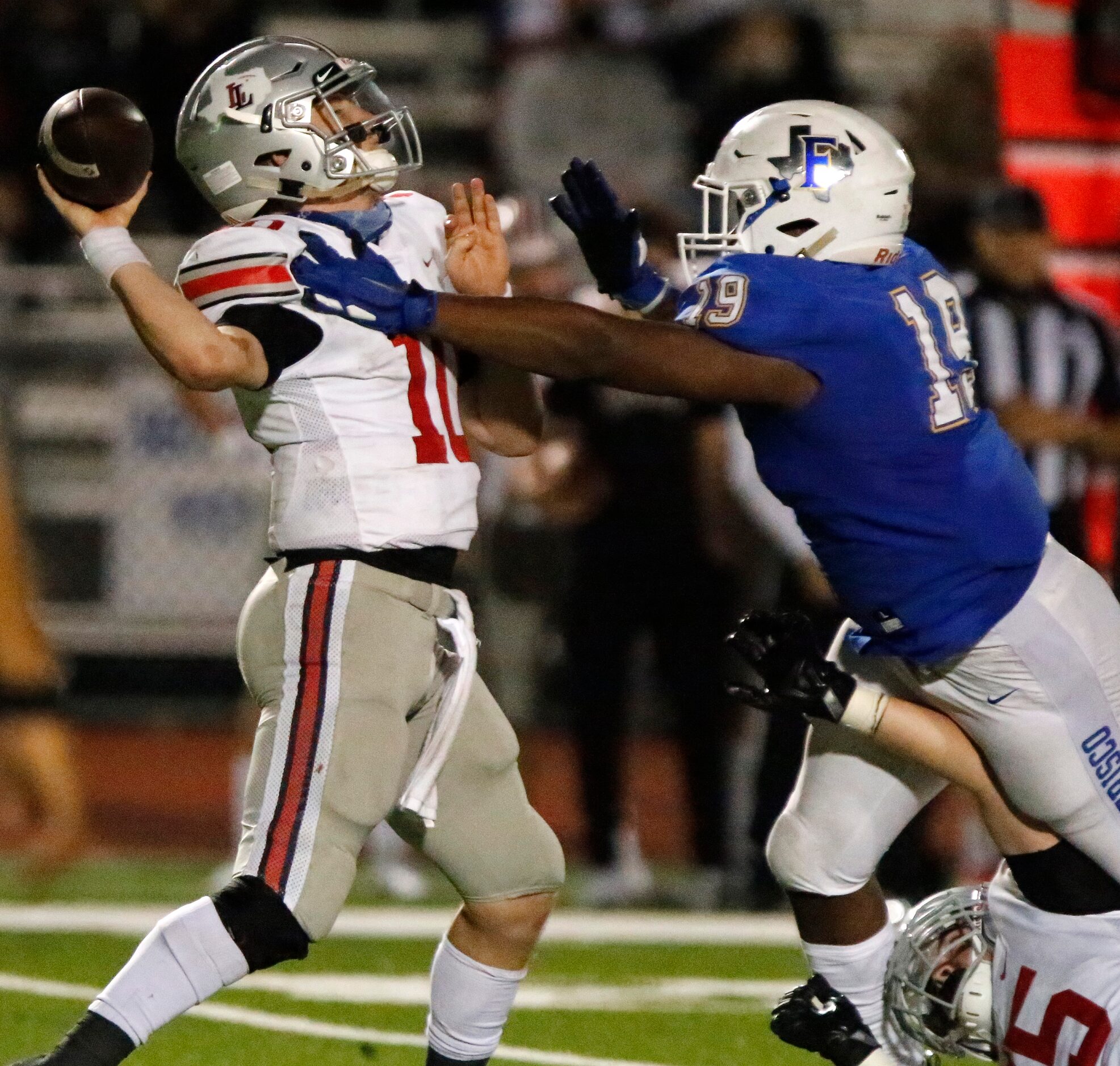 Lovejoy High School quarterback R.W. Rucker (10) is hurried by Frisco High School defensive...