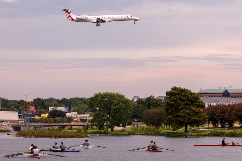 A jet flies over Bachman Lake as it prepares to land at Dallas Love Field airport on...