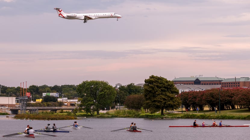 A JSX jet flies over Bachman Lake as it prepares to land at Dallas Love Field.