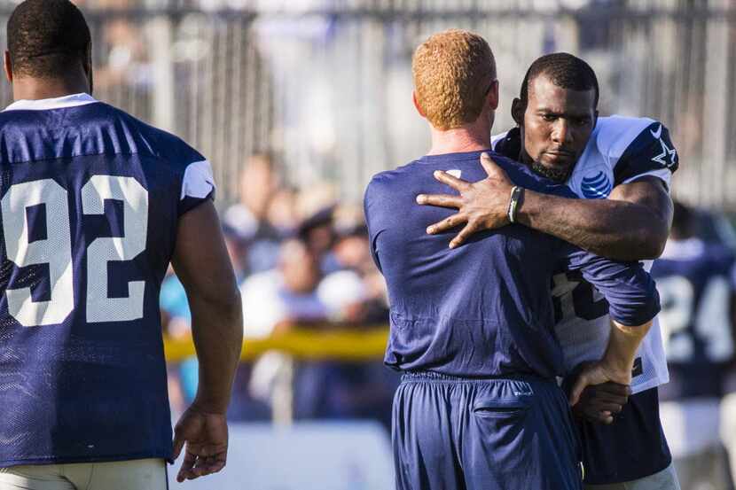 Dallas Cowboys head coach Jason Garrett hugs wide receiver Dez Bryant (88) after practice as...