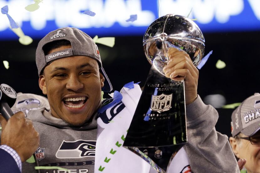 Seattle Seahawks' Malcolm Smith celebrates with the Vince Lombardi Trophy after the NFL...