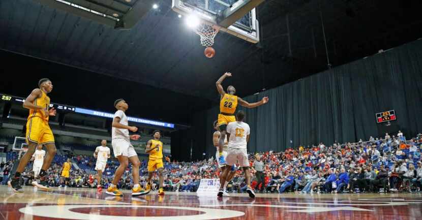 Oak Cliff Faith Academy's Mike Lenoir #22 scores over Houston Yates's Jabraylon Vaughn #12....